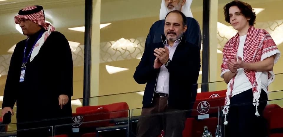 Cuatro personas en un palco de estadio aplaudiendo