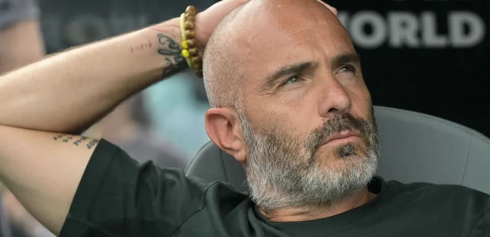 Entrenador sentado en el banquillo durante un partido