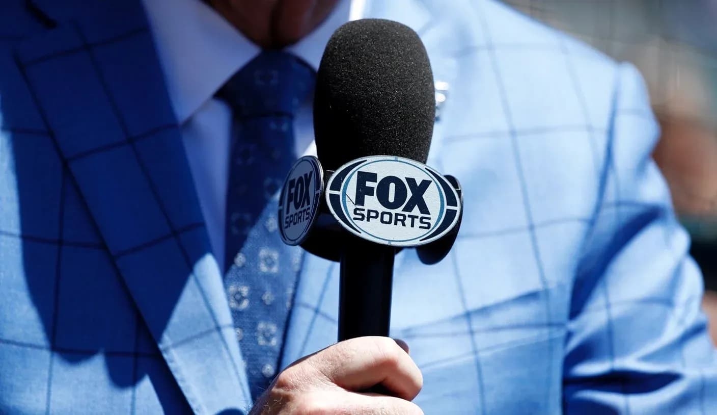 Mic with FOX Sports logo held by presenter
