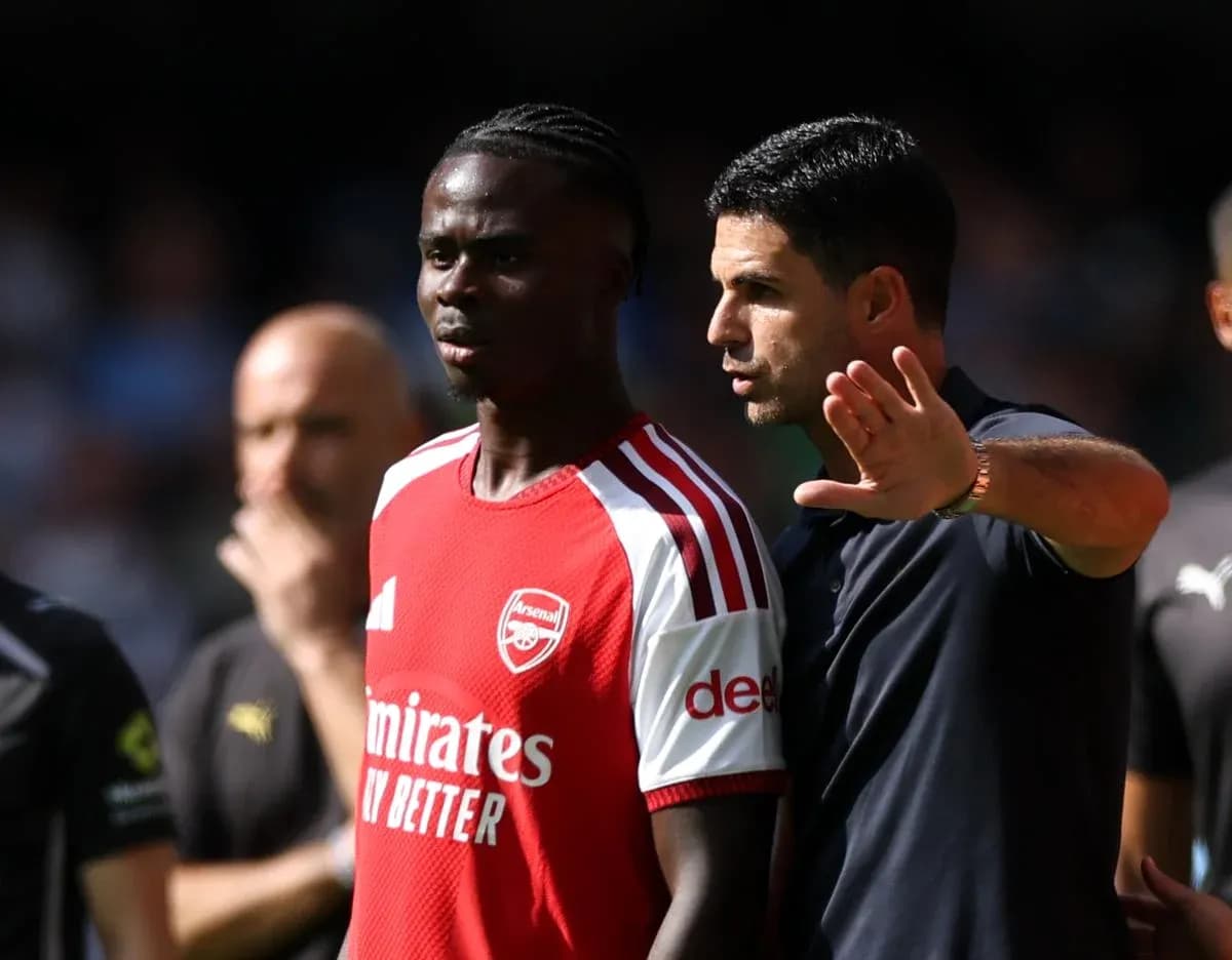 Entrenador hablando con jugador de Arsenal durante partido