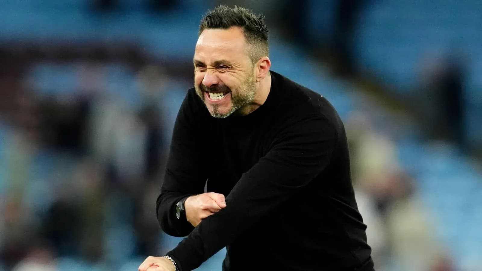 Entrenador celebrando en el banquillo durante el partido