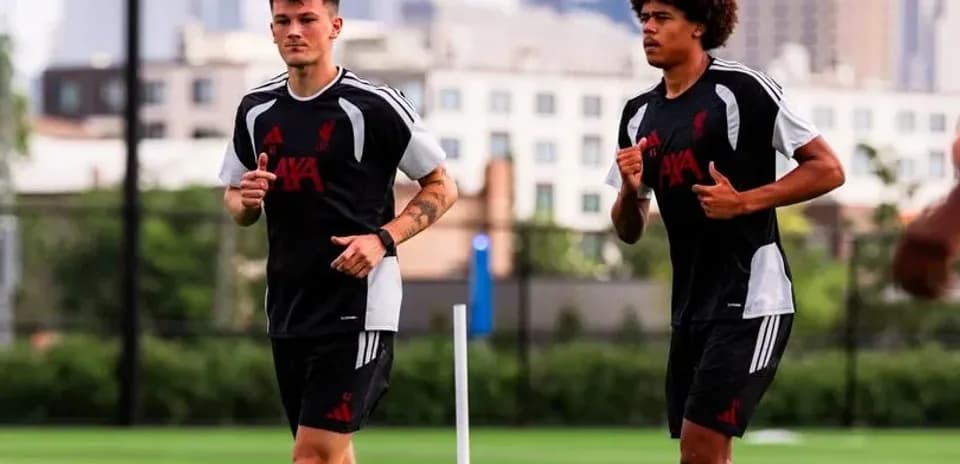 Dos jugadores de Liverpool corriendo en entrenamiento