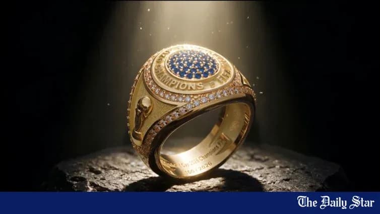 An illuminated championship ring on a stone surface