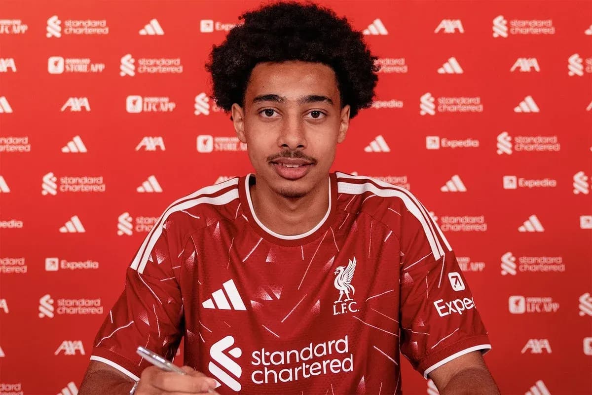 Jugador firmando contrato con camiseta del Liverpool