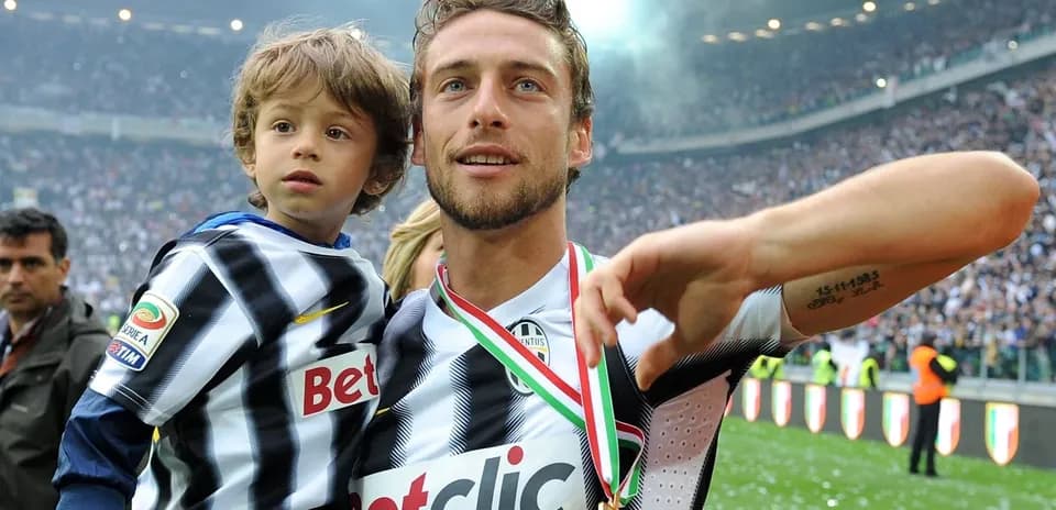 Jugador sosteniendo a un niño en el campo