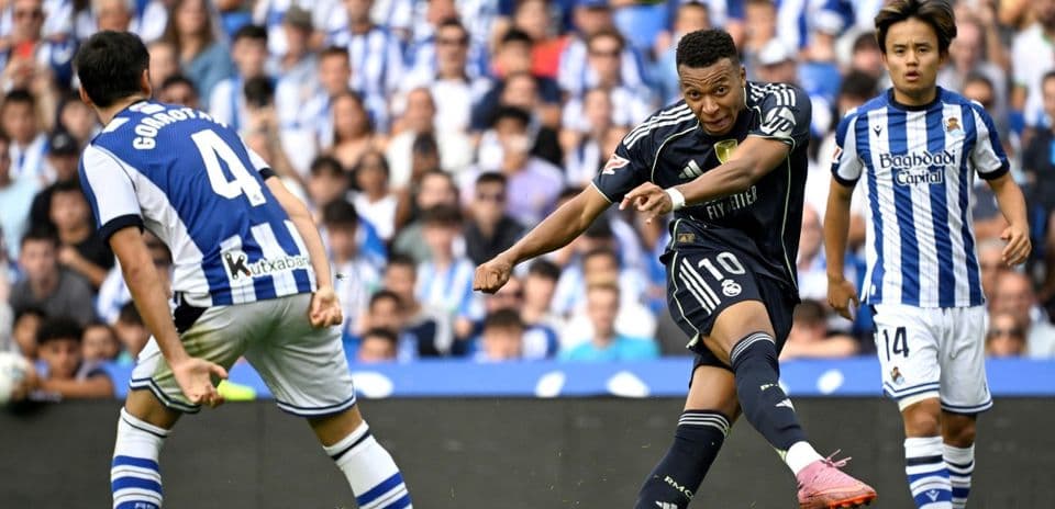 Un jugador de la Real Sociedad defendiendo a un atacante