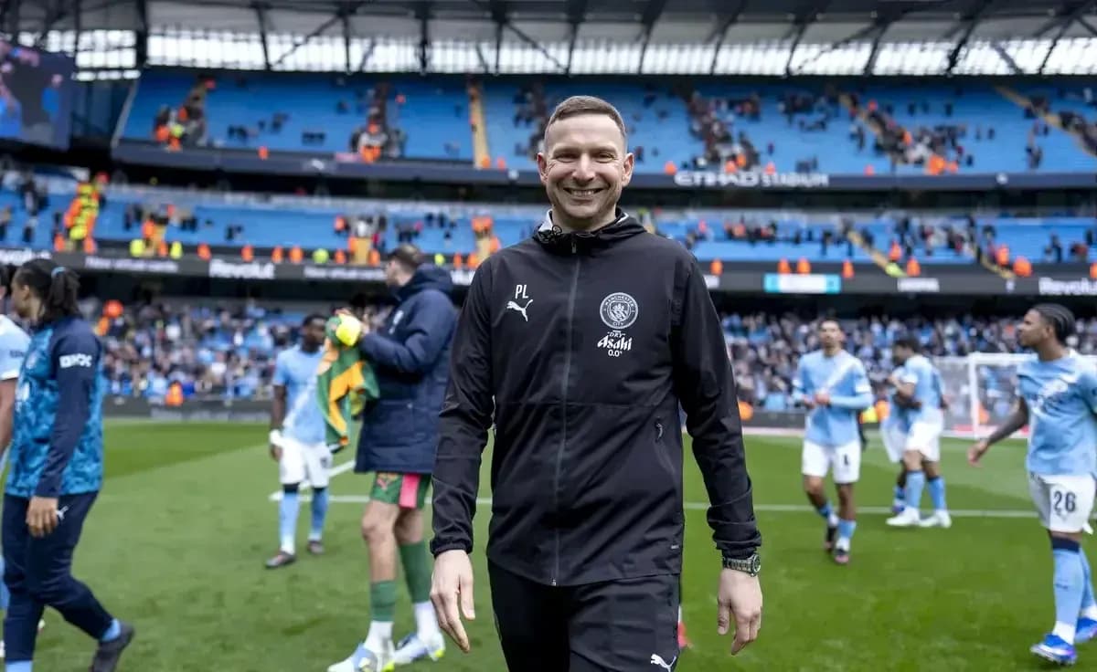 Entrenador sonriendo al final del partido en el estadio
