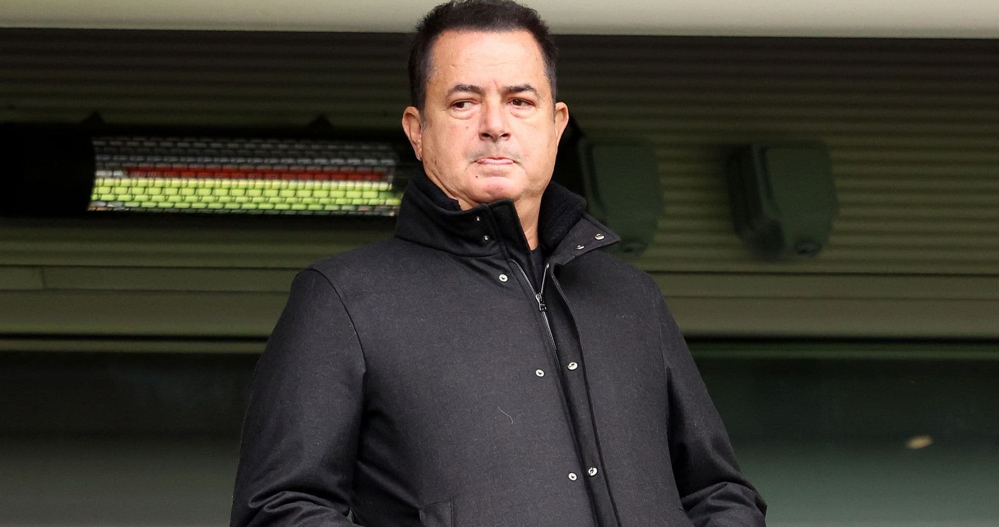 Hombre de pie en un palco durante un evento deportivo