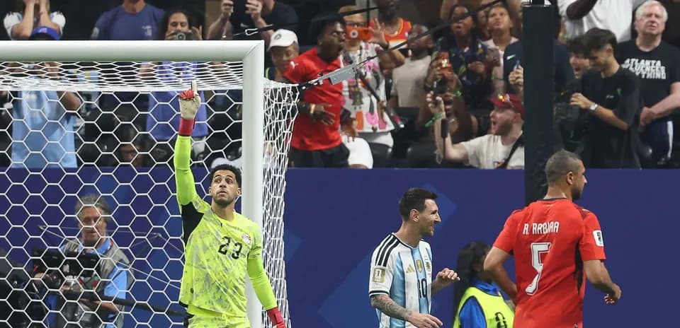 Portero señalando mientras Messi y rival avanzan
