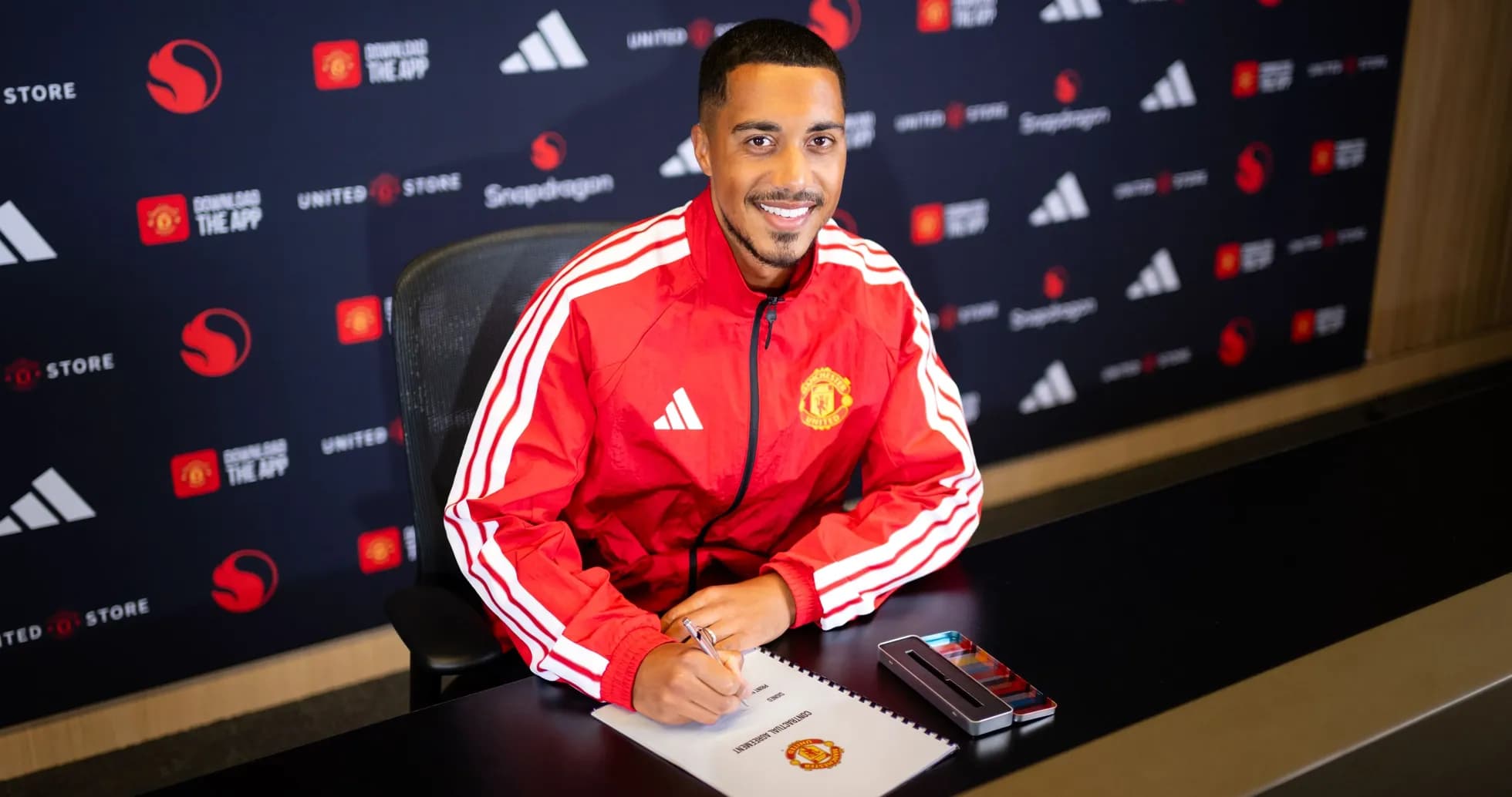 Jugador firmando contrato en presentación de Manchester United