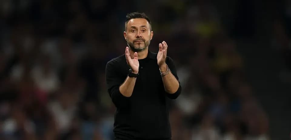 Entrenador aplaudiendo durante un partido de fútbol
