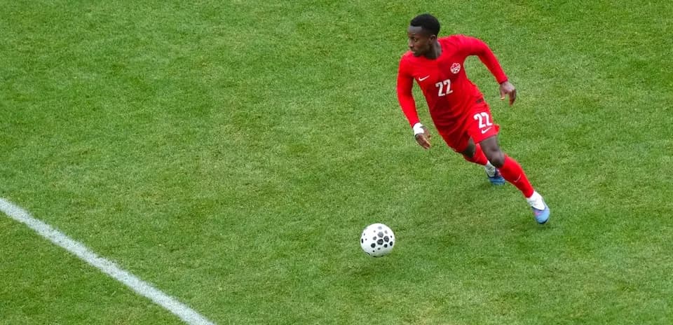 Jugador de Canadá corriendo tras el balón