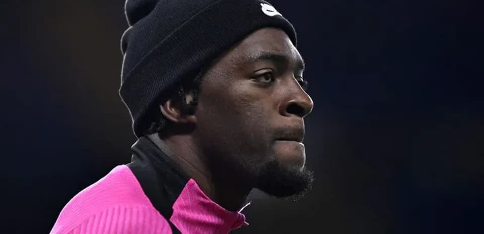 Jugador con gorro y camiseta rosa en el campo
