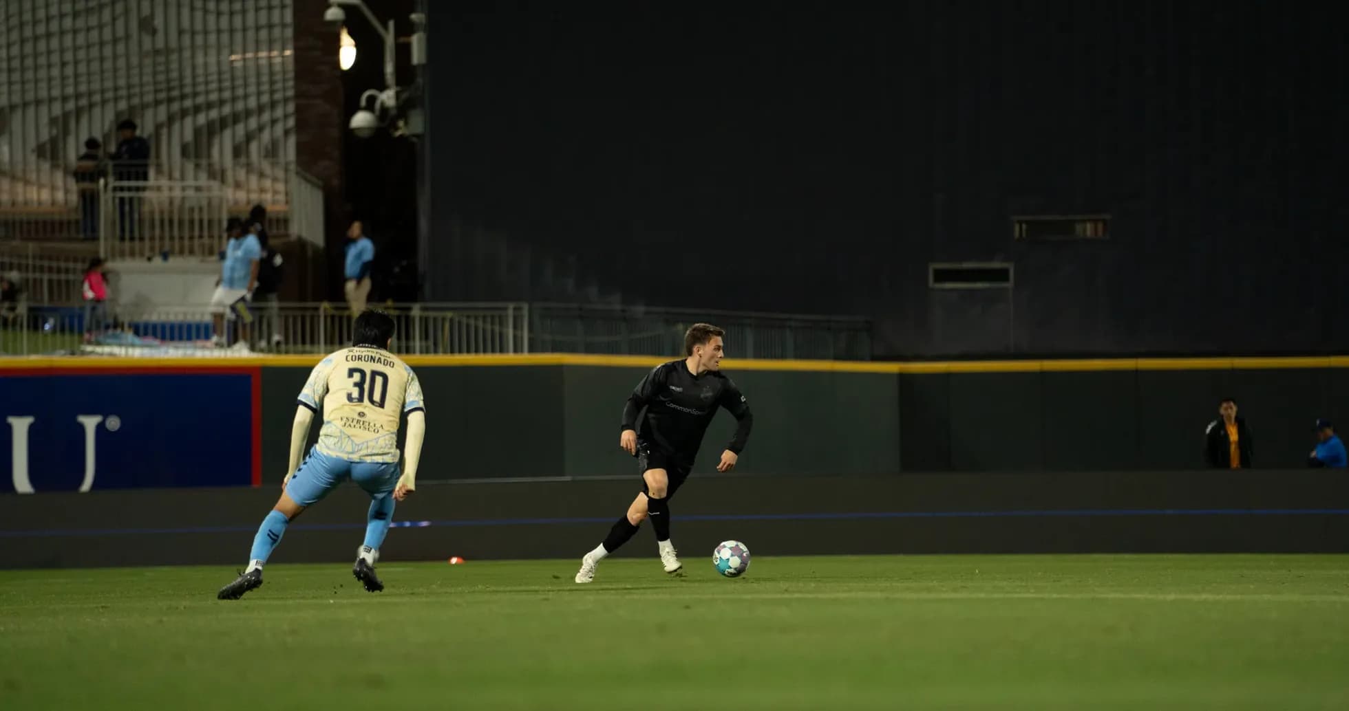 Jugador corriendo con balón durante el partido