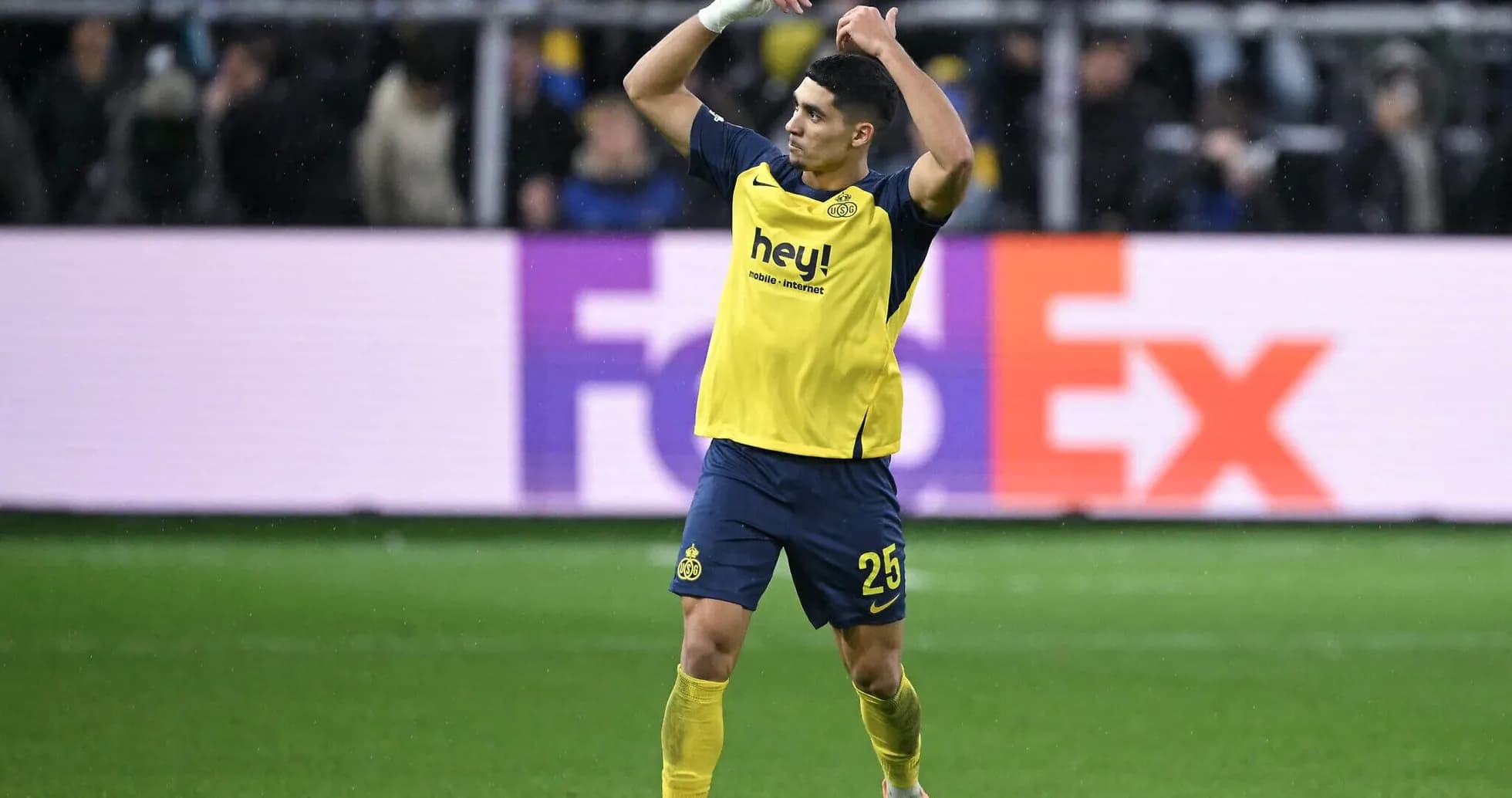 Jugador de fútbol con camiseta amarilla en el campo