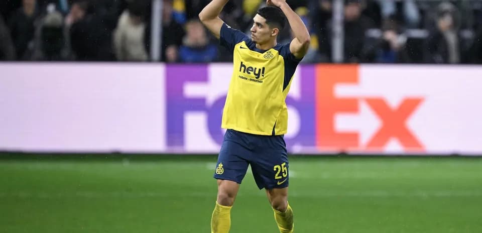 Jugador de fútbol con camiseta amarilla en el campo