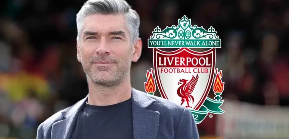 Hombre posando con el escudo del Liverpool FC
