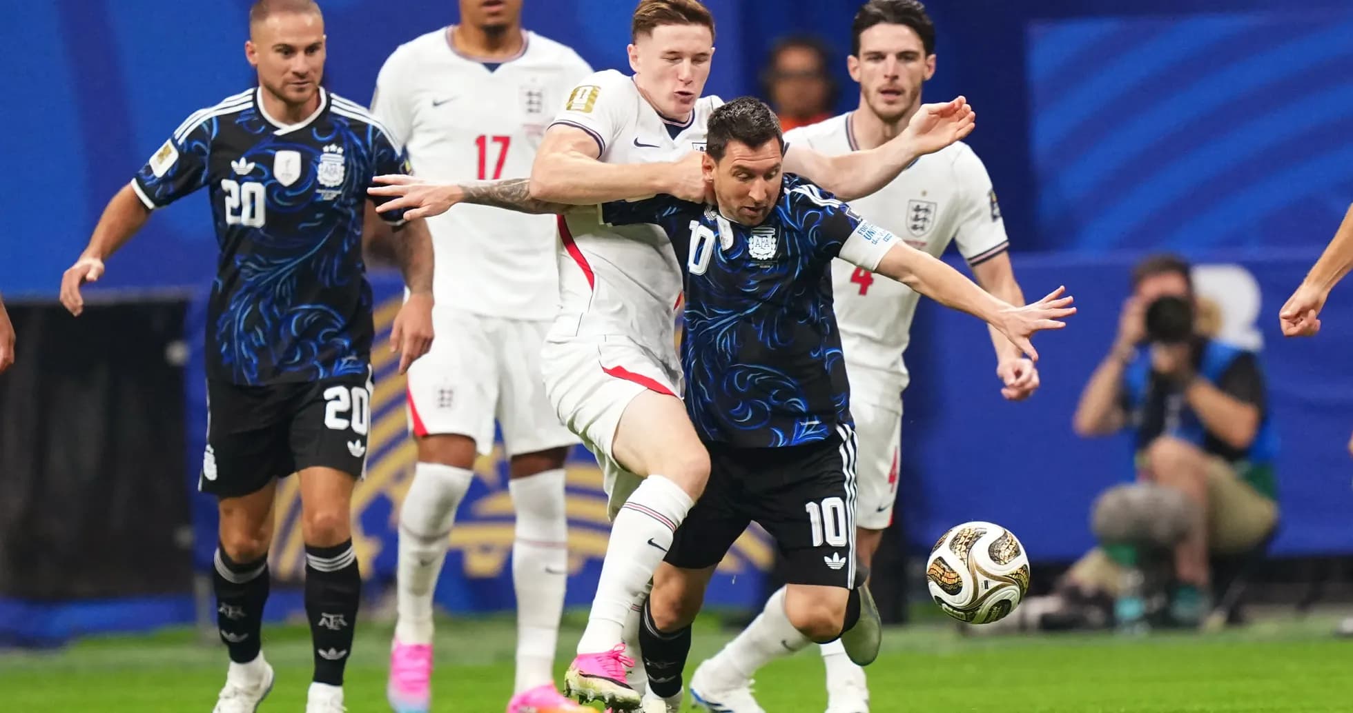 Lionel Messi regateando a un jugador inglés