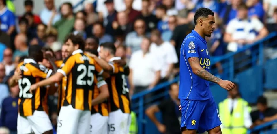Jugador de Chelsea caminando mientras el equipo rival celebra