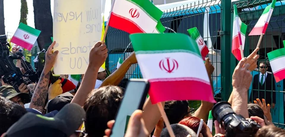 Protesters waving Iranian flags and holding signs
