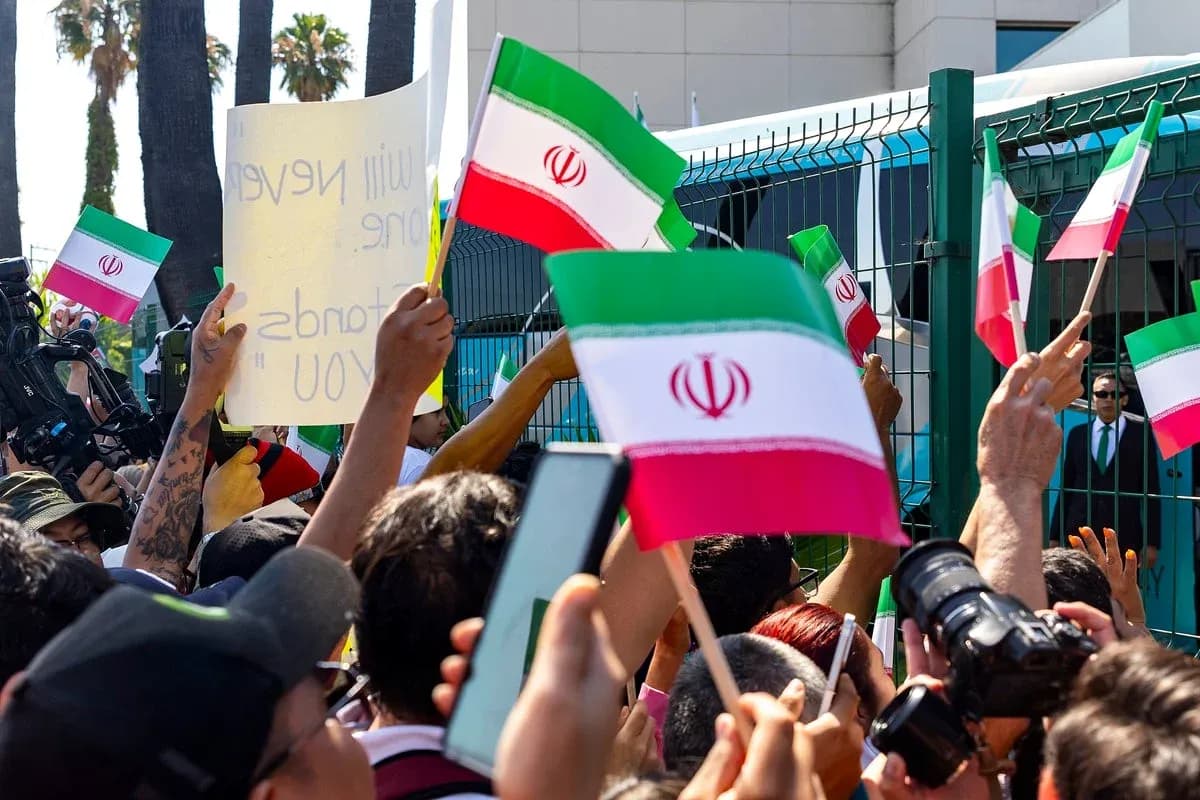 Protesters waving Iranian flags and holding signs