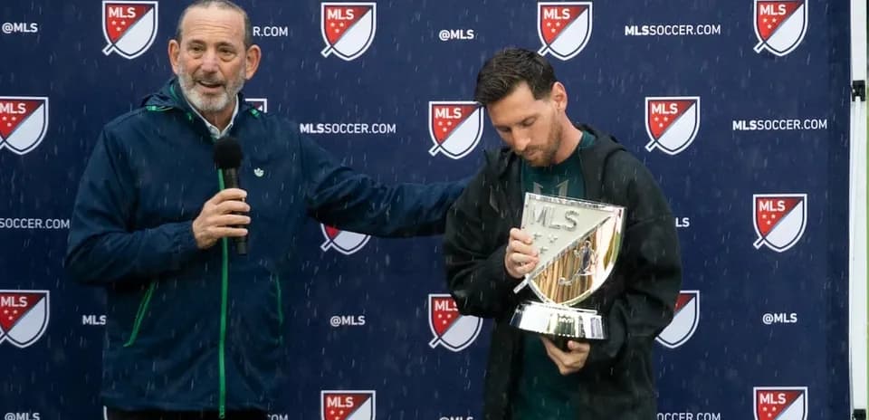 Lionel Messi holding MLS trophy during presentation