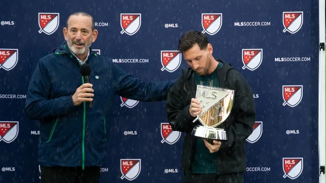Lionel Messi holding MLS trophy during presentation