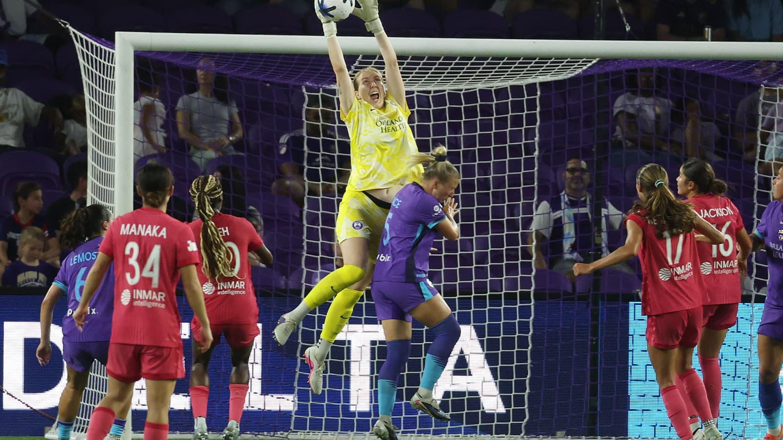 Portera atrapando el balón en un partido