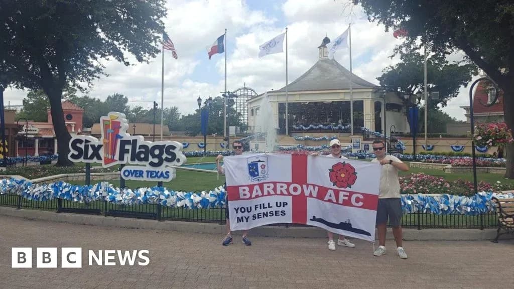 Dos aficionados sosteniendo una bandera en Six Flags