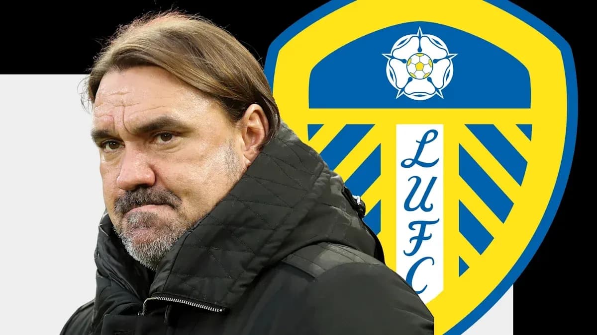 Entrenador de pie frente al escudo de Leeds United Entrenador de pie frente al escudo de Leeds United