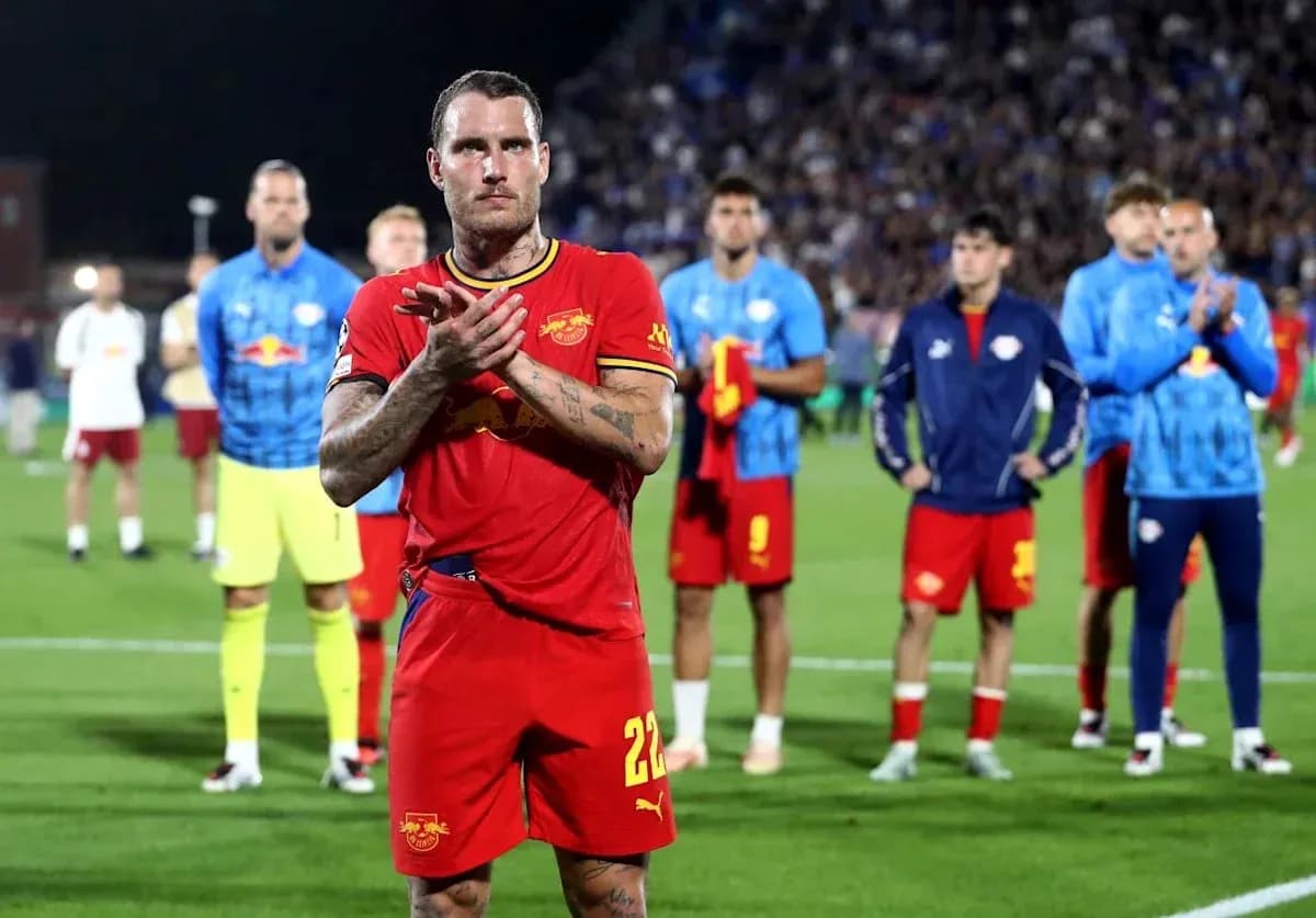 Jugador aplaudiendo con compañeros en el fondo Jugador aplaudiendo con compañeros en el fondo
