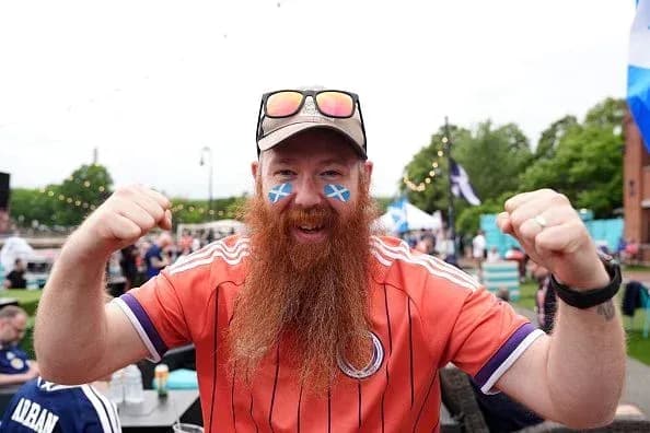A fan celebrating with Scottish face paint and jersey A fan celebrating with Scottish face paint and jersey