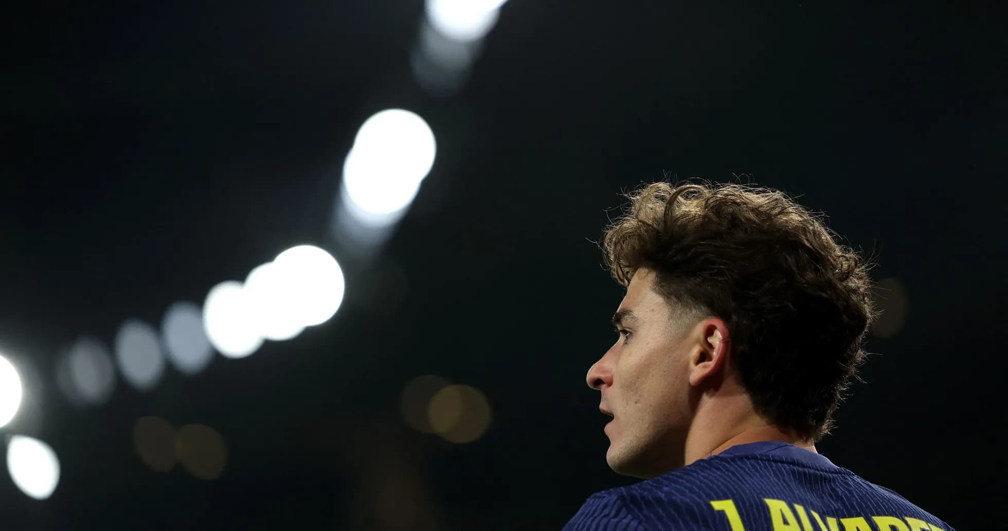 Jugador mirando hacia el campo bajo luces brillantes Jugador mirando hacia el campo bajo luces brillantes
